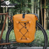 Bright orange ROCKBROS bicycle saddlebag with bungee cords attached to a bike.