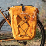 Splash-resistant orange ROCKBROS saddlebag for biking with added safety features.