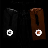 Black and brown ROCKBROS waterproof saddlebags with reflective logos.