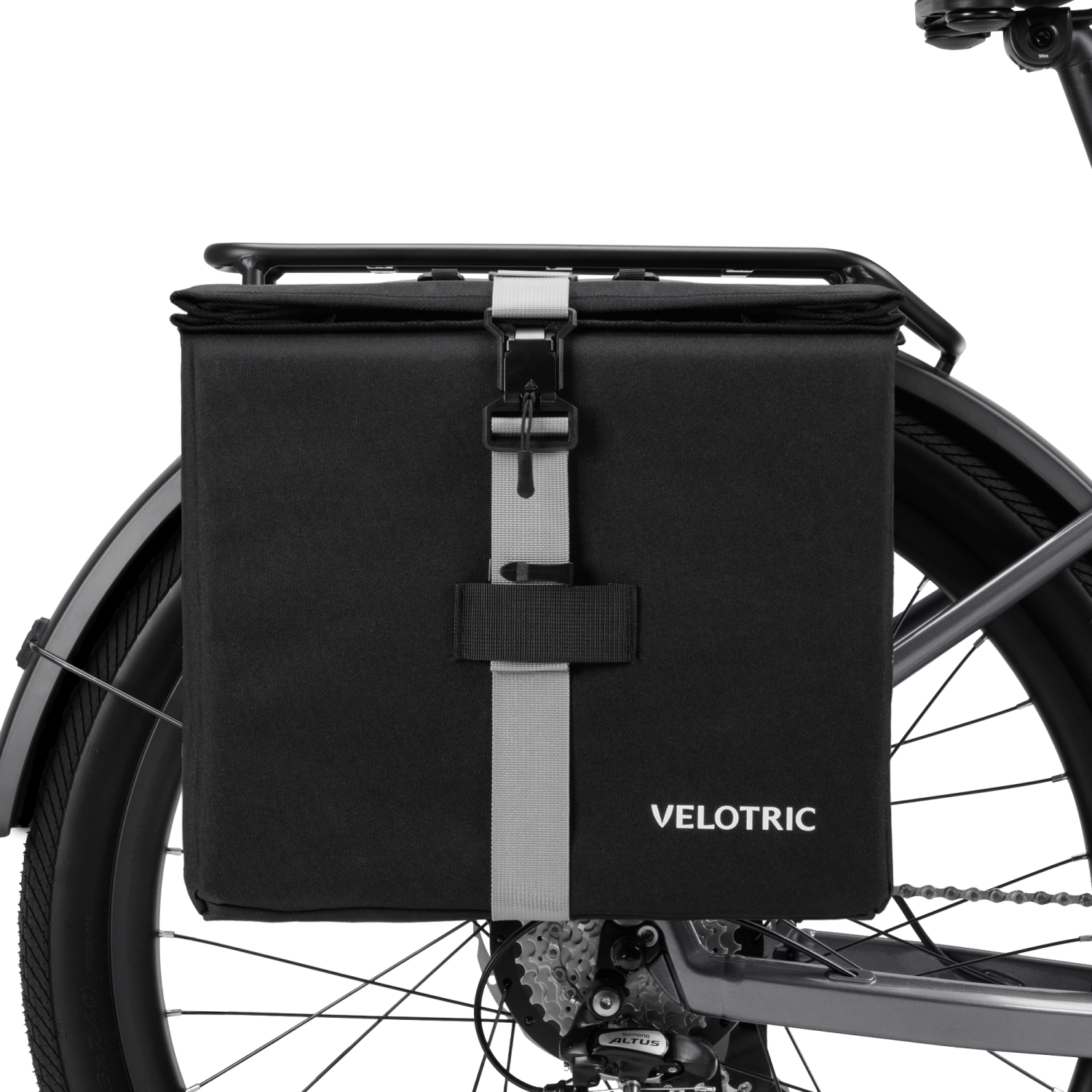 Velotric Rear Rack Pannier Bag in black with adjustable strap attached to bike rack