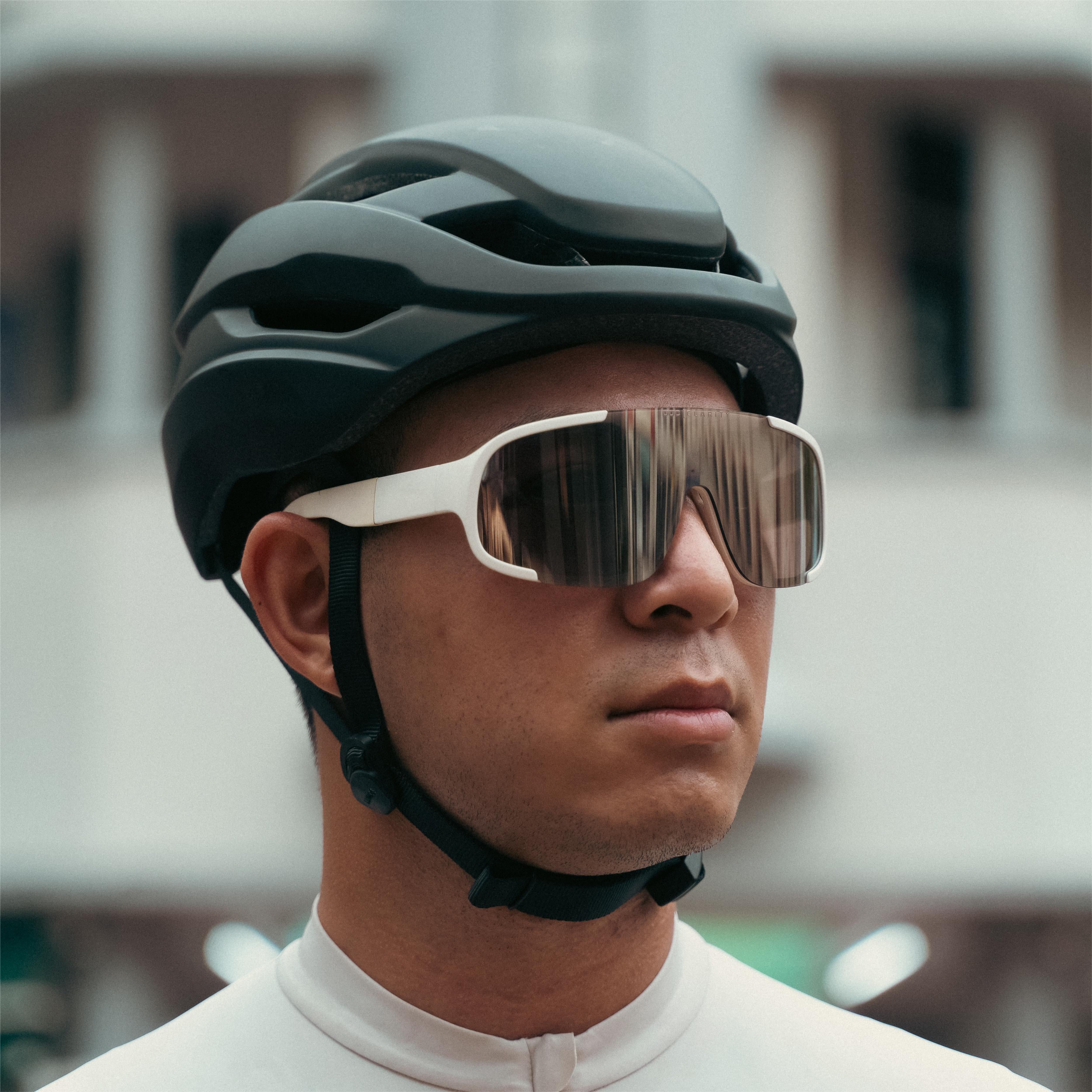 Cyclist wearing matte black Lumos Ultra Fly helmet with sunglasses.