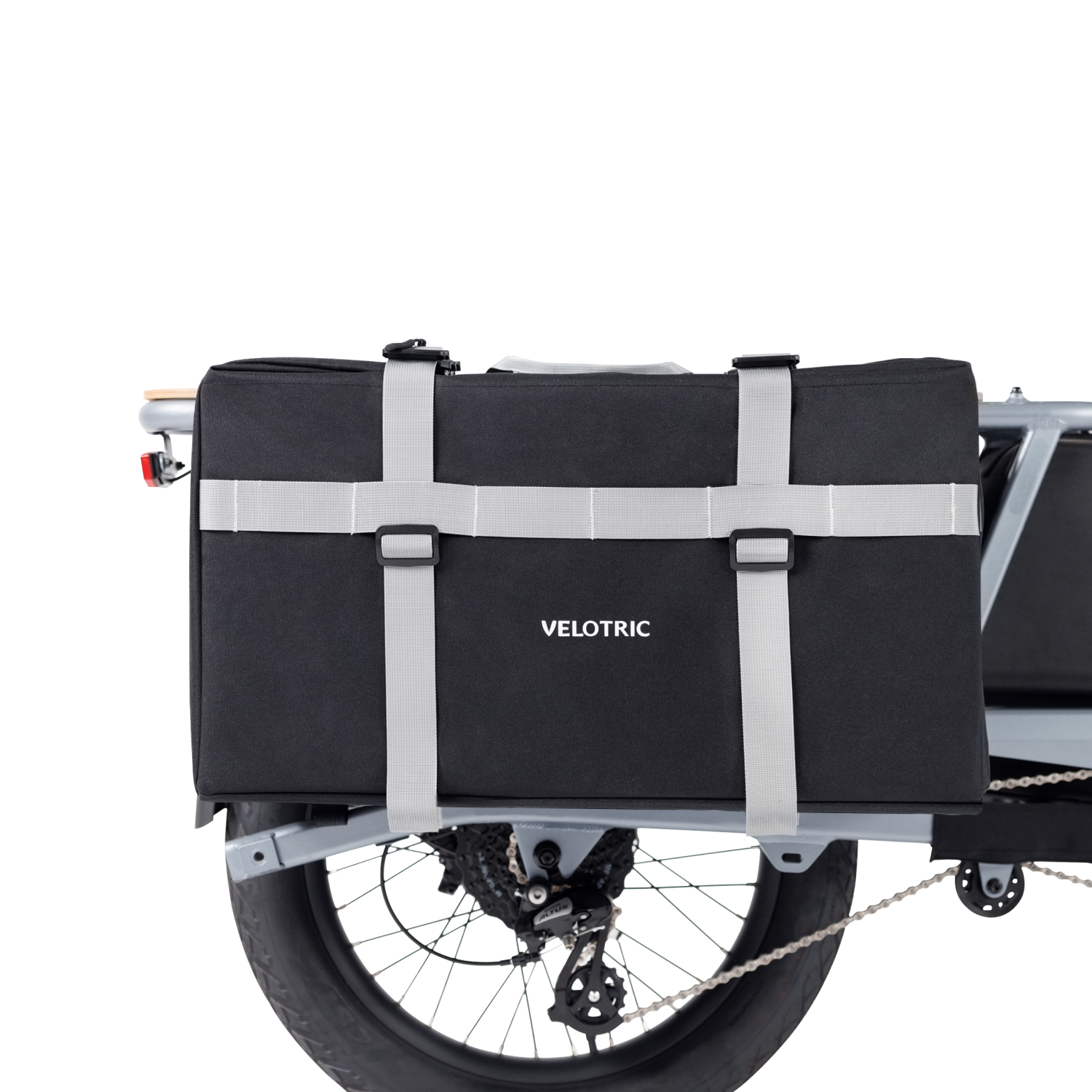 Black Velotric Packer Pannier Bag secured with adjustable straps on bike rack.